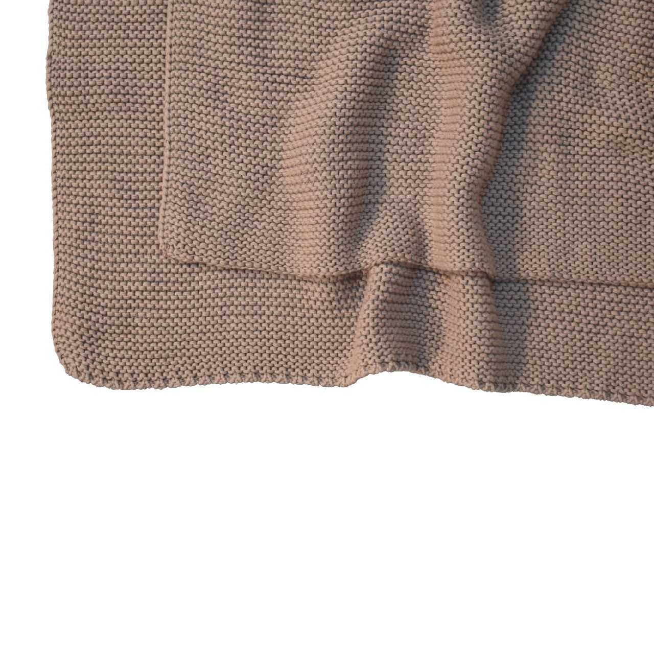 beige knitted throw